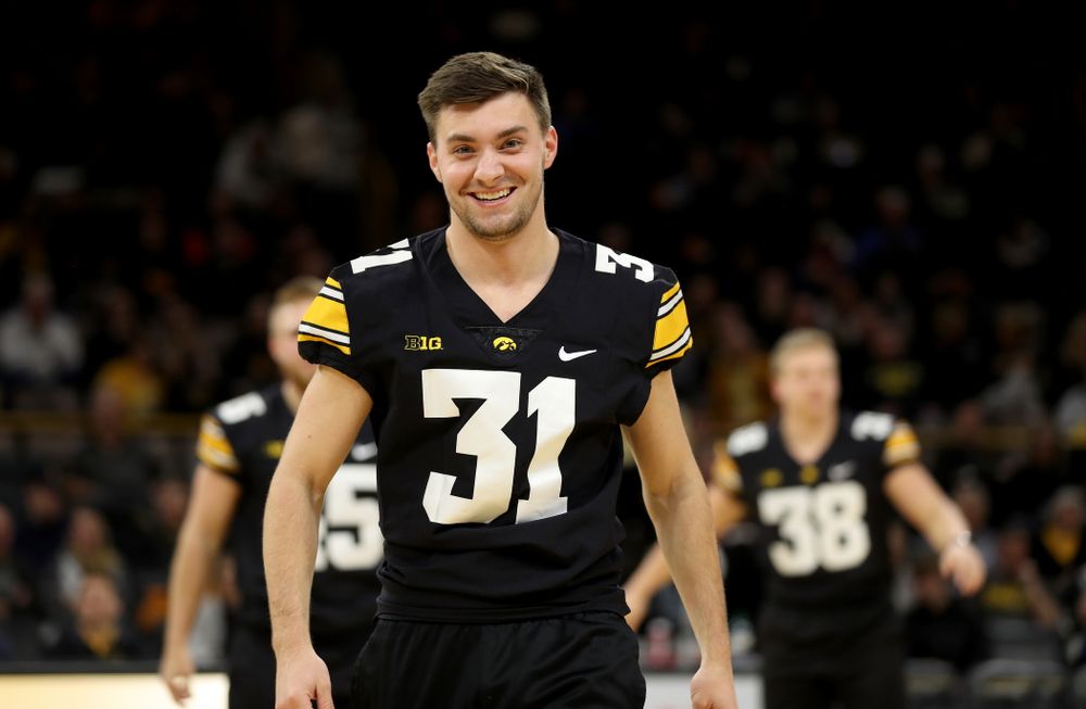 Members of the Hawkeye Football team performs with the Iowa Dance Team at halftime of the Iowa Hawkeyes game against the Ohio State Buckeyes Thursday, February 20, 2020 at Carver-Hawkeye Arena. (Brian Ray/hawkeyesports.com)