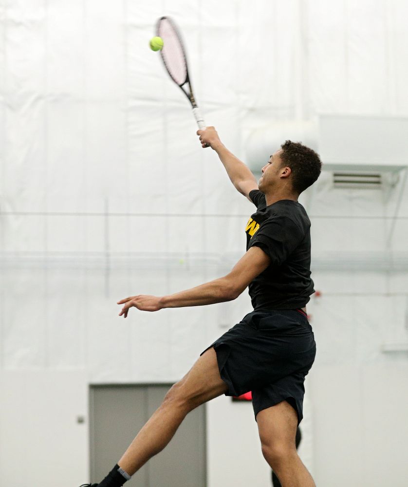 Iowa’s Oliver Okonkwo drives home a shot during his singles match at the Hawkeye Tennis and Recreation Complex in Iowa City on Friday, March 6, 2020. (Stephen Mally/hawkeyesports.com)