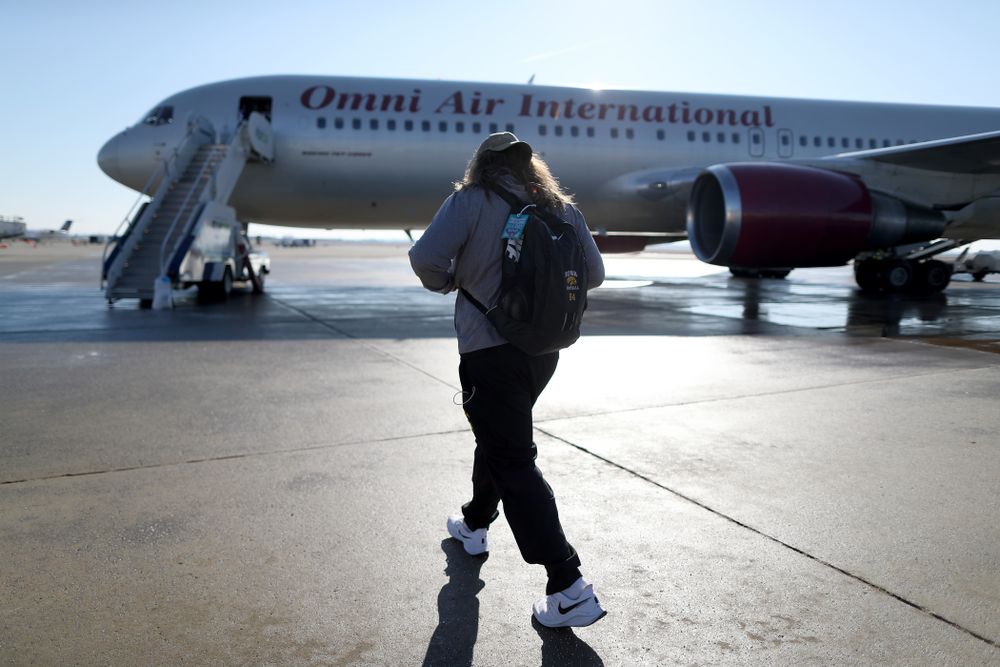 Iowa Hawkeyes offensive lineman Kyler Schott (64) boards the team plane at the Eastern Iowa Airport Saturday, December 21, 2019 on the way to San Diego, CA for the Holiday Bowl. (Brian Ray/hawkeyesports.com)