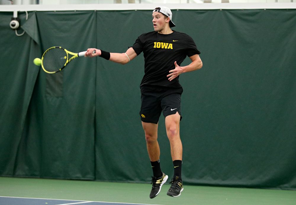 Iowa’s Joe Tyler hits a shot during his match against Marquette at the Hawkeye Tennis and Recreation Complex in Iowa City on Saturday, January 25, 2020. (Stephen Mally/hawkeyesports.com)