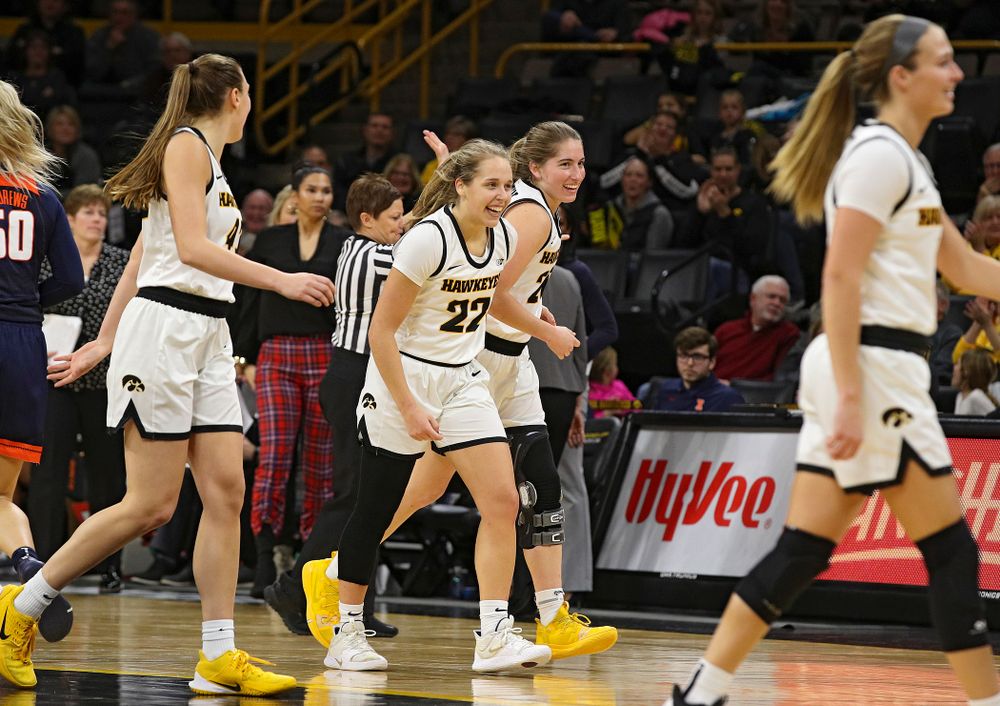Iowa Hawkeyes guard Kathleen Doyle (22) and guard Kate Martin (20) are all smiles as they head back to their bench during a timeout in the fourth quarter of their game at Carver-Hawkeye Arena in Iowa City on Tuesday, December 31, 2019. (Stephen Mally/hawkeyesports.com)