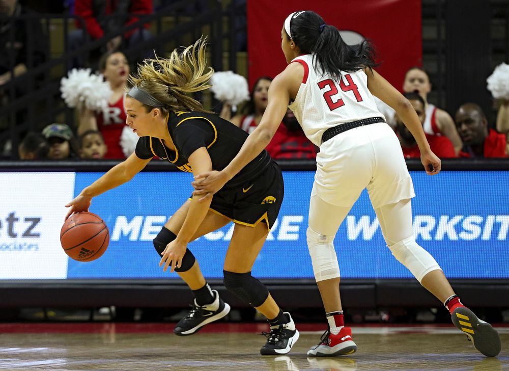 Iowa guard Makenzie Meyer (3) steals the ball away from Rutgers’ Arella Guirantes (24) during the first quarter of their game at the Rutgers Athletic Center in Piscataway, N.J. on Sunday, March 1, 2020. (Stephen Mally/hawkeyesports.com)