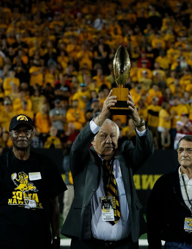 Tom Moore  holds up the  19058 National Championship  trophy as the team is introduced during  the Iowa Hawkeyes game against the Wisconsin Badgers Saturday, September 22, 2018 at Kinnick Stadium. (Brian Ray/hawkeyesports.com)