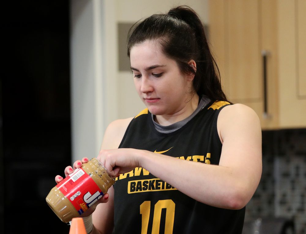 Iowa Hawkeyes forward Megan Gustafson (10) dips pretzels in peanut butter during media availability before their next game in the 2019 NCAA Women's Basketball Tournament at Carver Hawkeye Arena in Iowa City on Saturday, Mar. 23, 2019. (Stephen Mally for hawkeyesports.com)