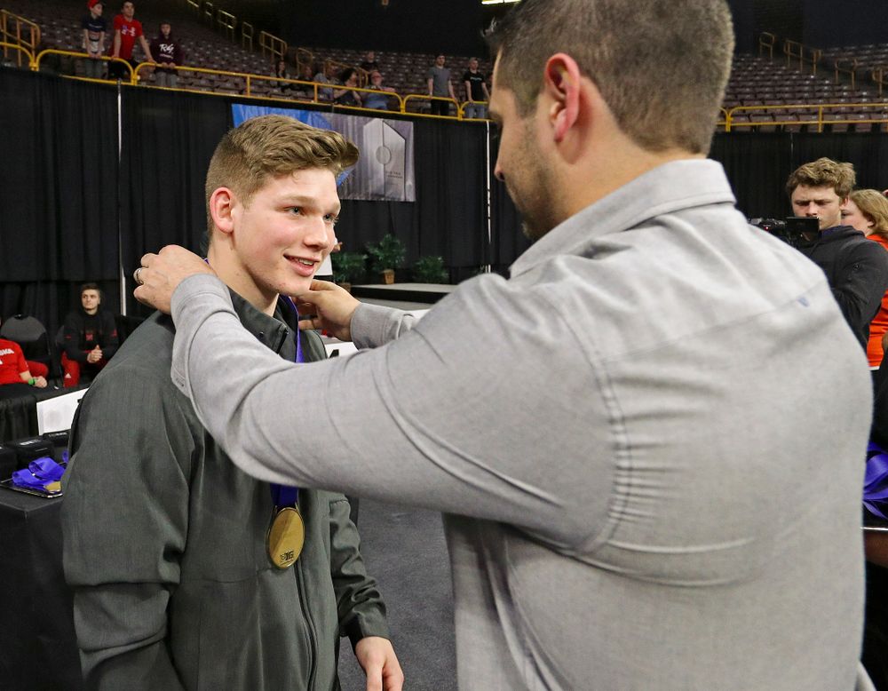 Iowa's Stewart Brown receives a bronze medal for this 
third place finish in the vault during the second day of the Big Ten Men's Gymnastics Championships at Carver-Hawkeye Arena in Iowa City on Saturday, Apr. 6, 2019. (Stephen Mally/hawkeyesports.com)
