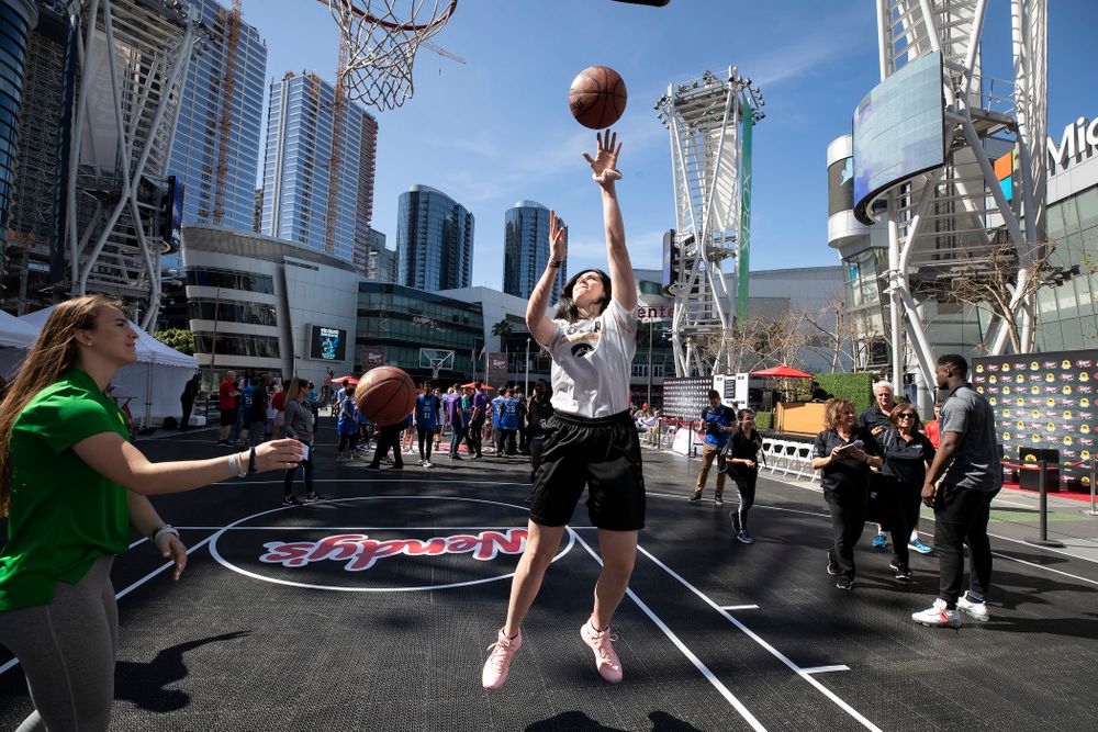 Iowa Hawkeyes forward Megan Gustafson (10) shoots baskets with OregonÕs Sabrina Ionescu before a Special Olympics event Friday, April 12, 2019 as part of the ESPN College Basketball Awards in the XBOX Plaza at LA Live.  (Brian Ray/hawkeyesports.com)