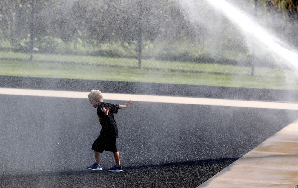 A young boy plays in the sprinklers as the field is watered at half time of the Iowa Hawkeyes game against the Penn Quakers Friday, September 14, 2018 at Grant Field. (Brian Ray/hawkeyesports.com)