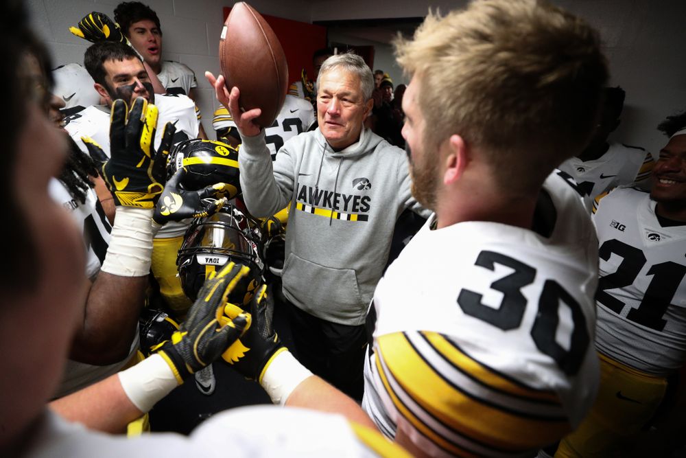 Iowa Hawkeyes defensive back Jake Gervase (30) presents the game ball to head coach Kirk Ferentz to commemorate his 150th win as head coach fo the Iowa Hawkeyes following their 63-0 win over the Illinois Fighting Illini Saturday, November 17, 2018 at Memorial Stadium in Champaign, Ill. (Brian Ray/hawkeyesports.com)