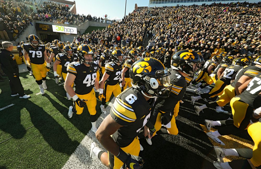 The Iowa Hawkeyes swarm as they take the field during halftime the game at Kinnick Stadium in Iowa City on Saturday, Nov 23, 2019. (Stephen Mally/hawkeyesports.com)