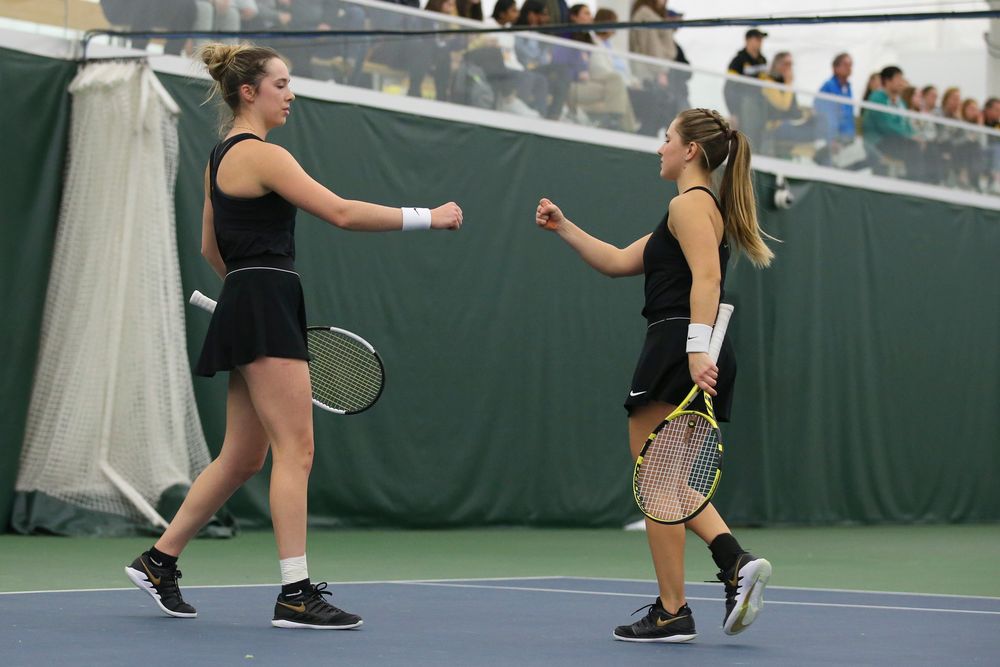 Iowa’s Samantha Mannix and Danielle Burich bump fists during doubles during the Iowa women’s tennis meet vs UNI  on Saturday, February 29, 2020 at the Hawkeye Tennis and Recreation Complex. (Lily Smith/hawkeyesports.com)