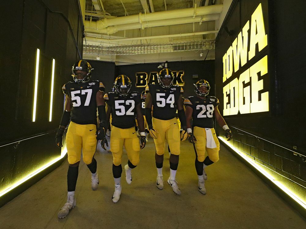 Iowa Hawkeyes defensive end Chauncey Golston (57), linebacker Amani Jones (52), defensive tackle Daviyon Nixon (54), and running back Toren Young (28) walk down the tunnel to take the field for the second half of their game at Kinnick Stadium in Iowa City on Saturday, Sep 28, 2019. (Stephen Mally/hawkeyesports.com)