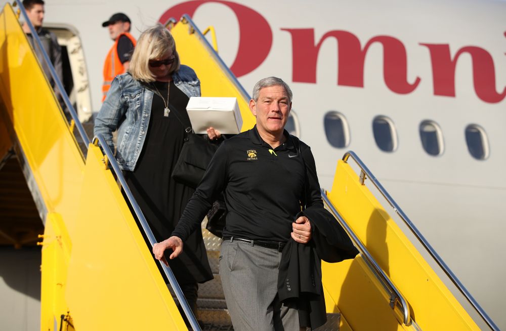Iowa Hawkeyes head coach Kirk Ferentz disembarks the team plane Wednesday, December 26, 2018 as they arrive in Tampa, Florida for the Outback Bowl. (Brian Ray/hawkeyesports.com)