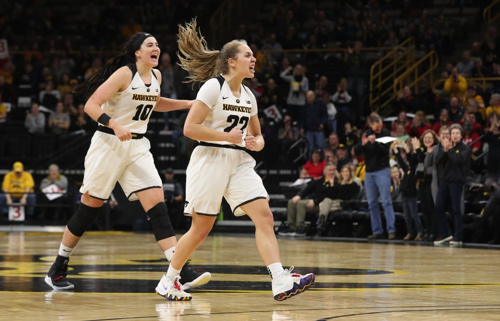 Iowa Hawkeyes guard Kathleen Doyle (22) and forward Megan Gustafson (10)  react to an and one by forward Hannah Stewart (21) against the Purdue Boilermakers Sunday, January 27, 2019 at Carver-Hawkeye Arena. (Brian Ray/hawkeyesports.com)