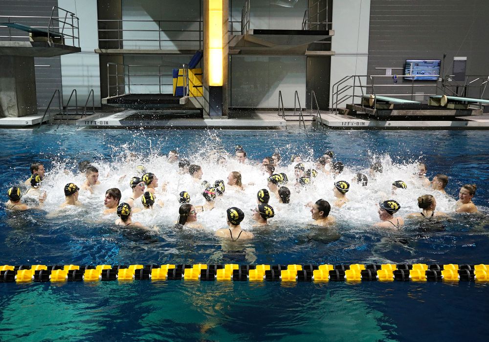The Hawkeyes sing the Fight Song in the pool after their meet at the Campus Recreation and Wellness Center in Iowa City on Friday, February 7, 2020. (Stephen Mally/hawkeyesports.com)