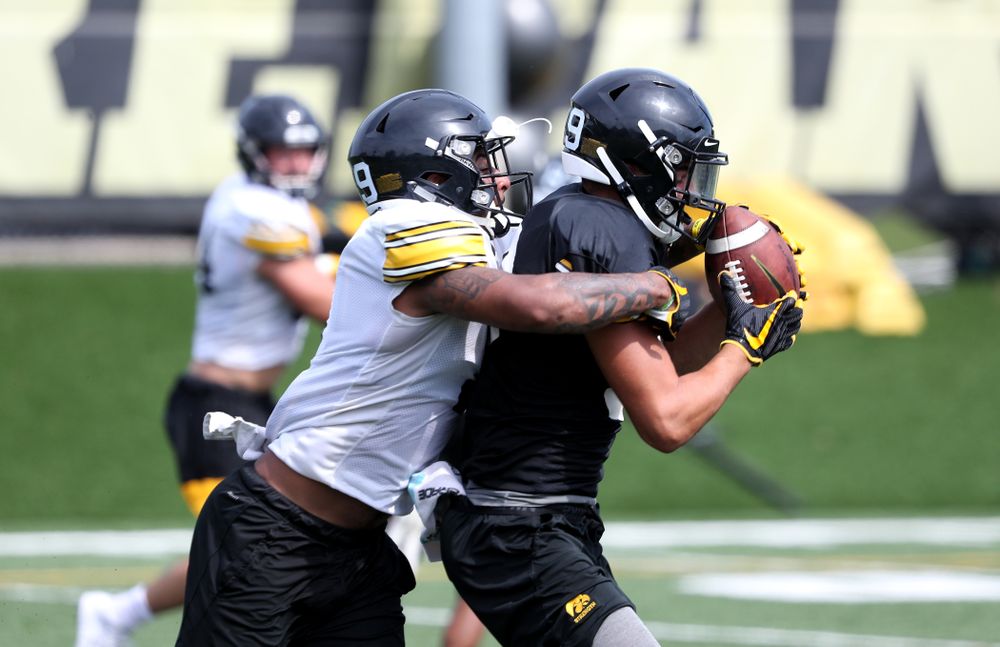 Iowa Hawkeyes wide receiver Nico Ragaini (89) and defensive back Geno Stone (9) During Fall Camp Practice No. 4 Monday, August 5, 2019 at the Ronald D. and Margaret L. Kenyon Football Practice Facility. (Brian Ray/hawkeyesports.com)