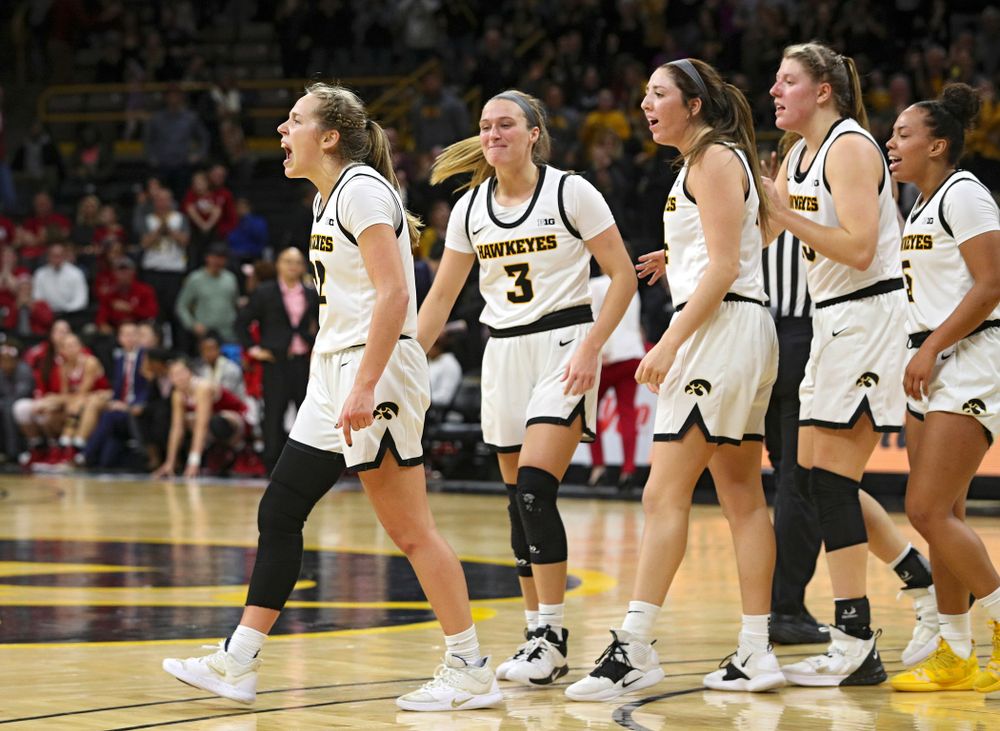 Iowa Hawkeyes guard Kathleen Doyle (22) celebrates with guard Makenzie Meyer (3), guard Mckenna Warnock (14), forward Monika Czinano (25), and guard Alexis Sevillian (5) after making a basket while being fouled during the fourth quarter of their game at Carver-Hawkeye Arena in Iowa City on Sunday, January 12, 2020. (Stephen Mally/hawkeyesports.com)