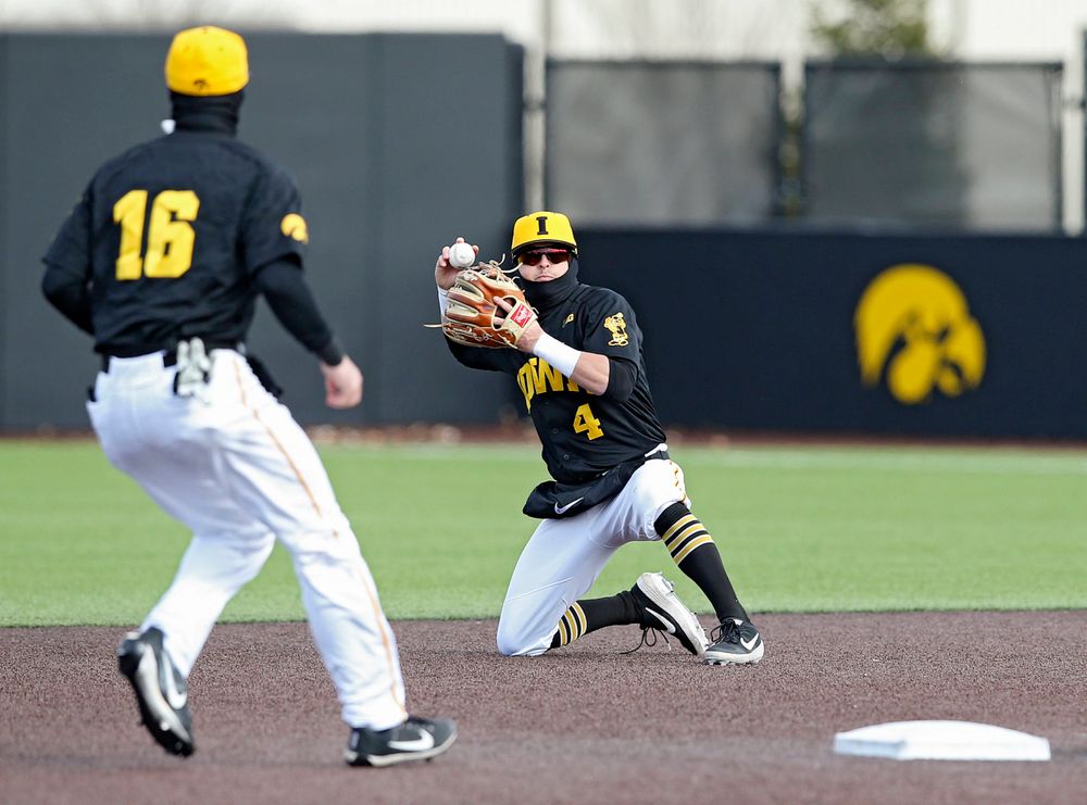 Iowa Hawkeyes second baseman Mitchell Boe (4) prepares to throw the ball to shortstop Tanner Wetrich (16) to start a double play during the sixth inning of their game against Illinois at Duane Banks Field in Iowa City on Saturday, Mar. 30, 2019. (Stephen Mally/hawkeyesports.com)
