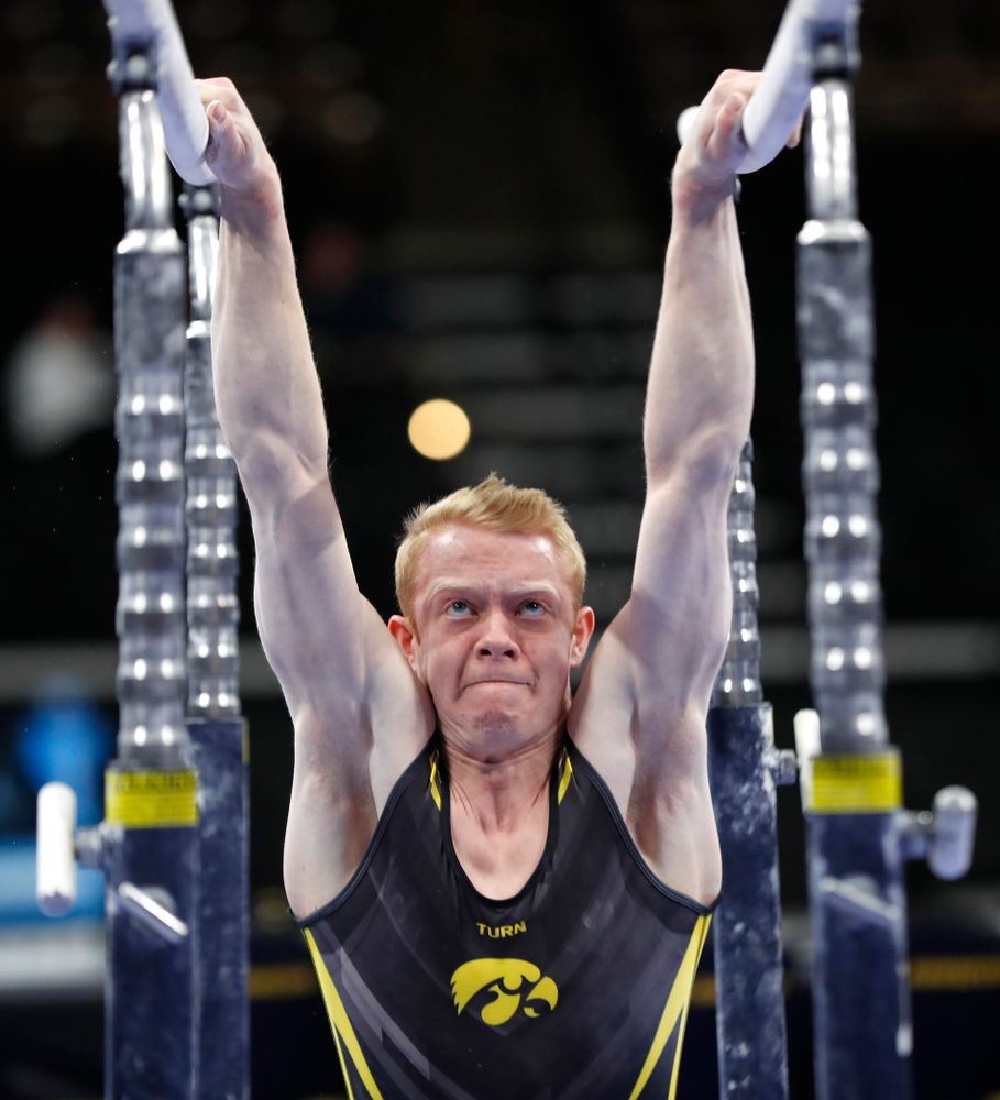 Nick Merryman competes on the bars against Minnesota and Air Force 