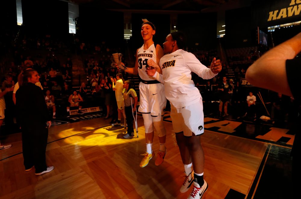 Iowa Hawkeyes forward Carly Mohns (34) and guard Zion Sanders (24) 