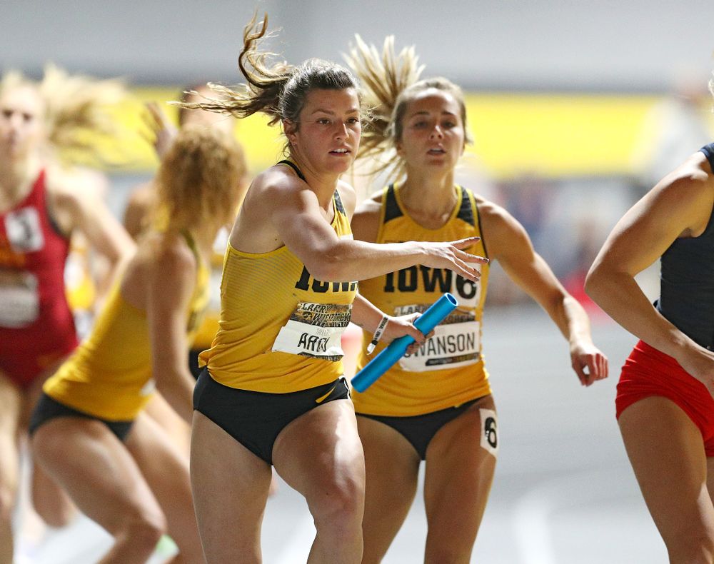 Iowa’s Taylor Arco (from left) takes the baton from Addie Swanson as they run the women’s 1600 meter relay event during the Larry Wieczorek Invitational at the Recreation Building in Iowa City on Saturday, January 18, 2020. (Stephen Mally/hawkeyesports.com)