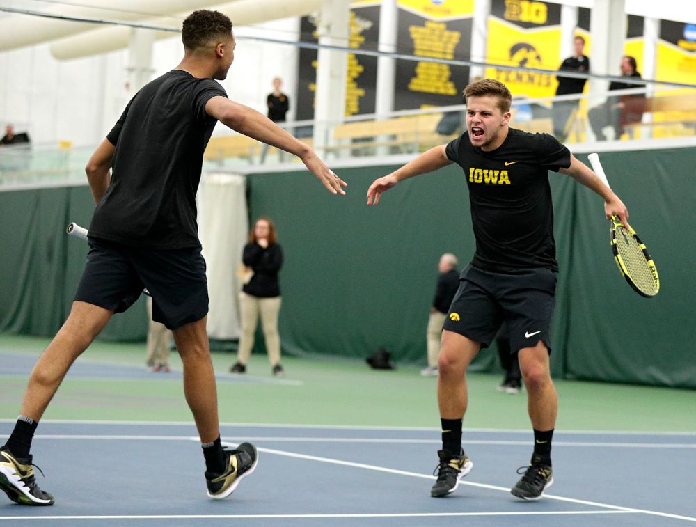 Iowa’s Oliver Okonkwo (from left) and Will Davies celebrate a point during their doubles match at the Hawkeye Tennis and Recreation Complex in Iowa City on Friday, February 14, 2020. (Stephen Mally/hawkeyesports.com)
