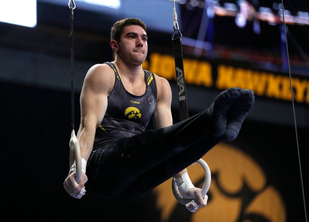 Dominic Tommaso competes on the rings against Illinois 