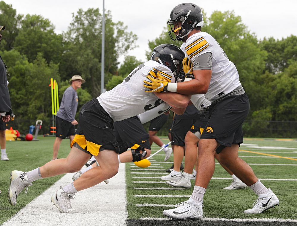 Iowa Hawkeyes defensive lineman Zach VanValkenburg (97) hits defensive end A.J. Epenesa (94) as they run a drill during Fall Camp Practice No. 15 at the Hansen Football Performance Center in Iowa City on Monday, Aug 19, 2019. (Stephen Mally/hawkeyesports.com)