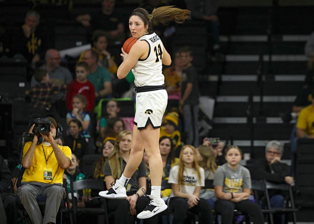Iowa Hawkeyes guard Mckenna Warnock (14) pulls down a rebound during the third quarter of their game at Carver-Hawkeye Arena in Iowa City on Sunday, January 26, 2020. (Stephen Mally/hawkeyesports.com)