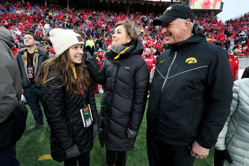 Iowa hero Katie Gudenkauf talks with Iowa Governor Kim Reynolds and Henry B. and Patricia B. Tippie Director of Athletics Chair Gary Barta at half-time of the Iowa Hawkeyes game against the Nebraska Cornhuskers Friday, November 29, 2019 at Memorial Stadium in Lincoln, Neb. (Brian Ray/hawkeyesports.com)