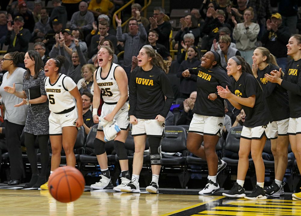 The Iowa bench reacts after forward Amanda Ollinger (not pictured) maked a basket while being fouled during the third quarter of their game at Carver-Hawkeye Arena in Iowa City on Sunday, January 12, 2020. (Stephen Mally/hawkeyesports.com)