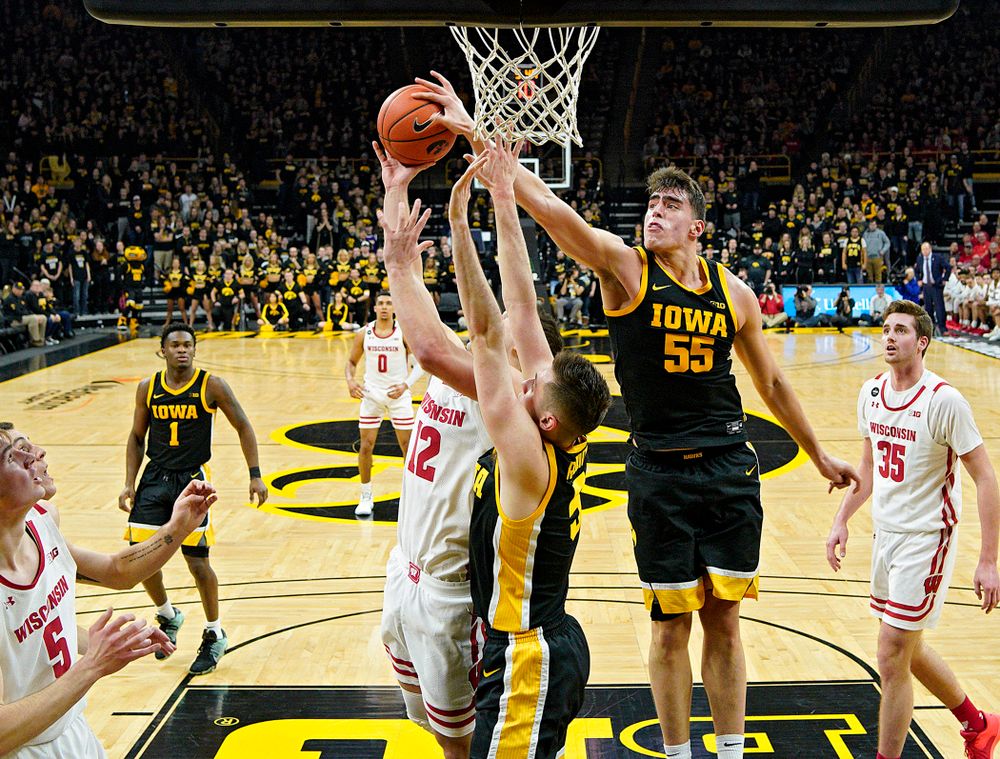 Iowa Hawkeyes center Luka Garza (55) blocks a shot by Wisconsin Badgers guard Trevor Anderson (12) during the first half of their game at Carver-Hawkeye Arena in Iowa City on Monday, January 27, 2020. (Stephen Mally/hawkeyesports.com)