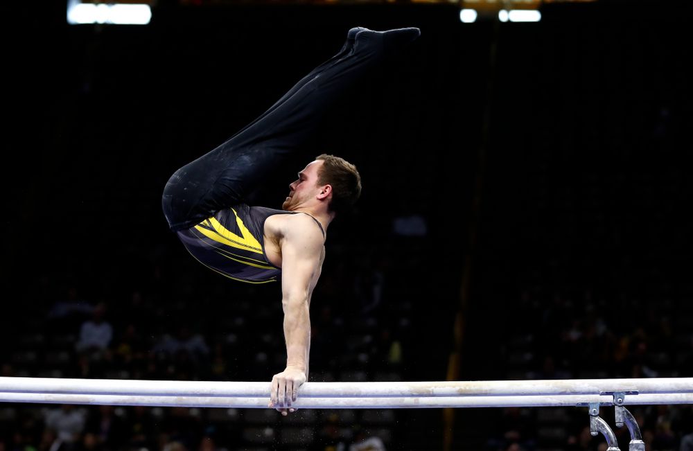 Dylan Ellsworth competes on the bars against Illinois 