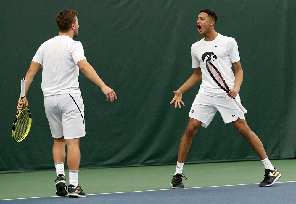 Iowa’s Will Davies (from left) and Oliver Okonkwo celebrate a point during their doubles match at the Hawkeye Tennis and Recreation Complex in Iowa City on Sunday, February 16, 2020. (Stephen Mally/hawkeyesports.com)