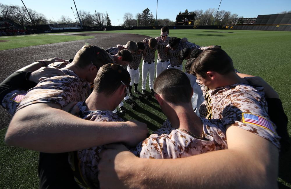 The Iowa Hawkeyes gather before their game against the Nebraska Cornhuskers on Military Appreciation Night Friday, April 19, 2019 at Duane Banks Field. (Brian Ray/hawkeyesports.com)