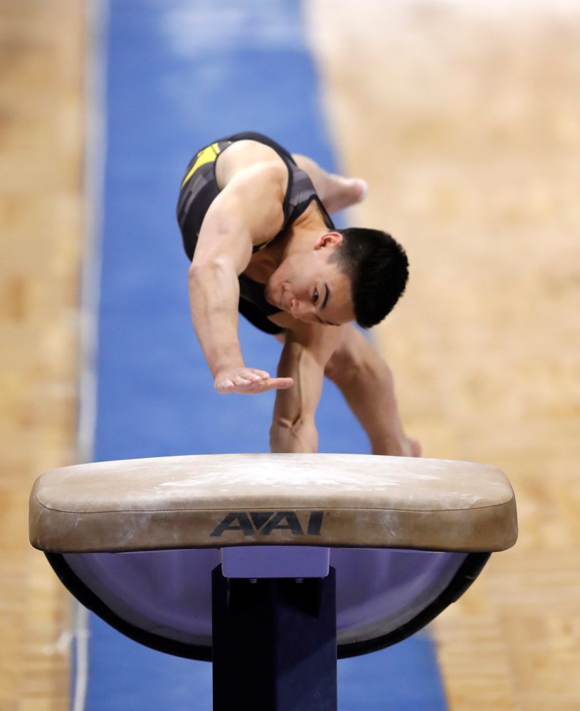 Brandon Wong competes on the vault against Illinois 