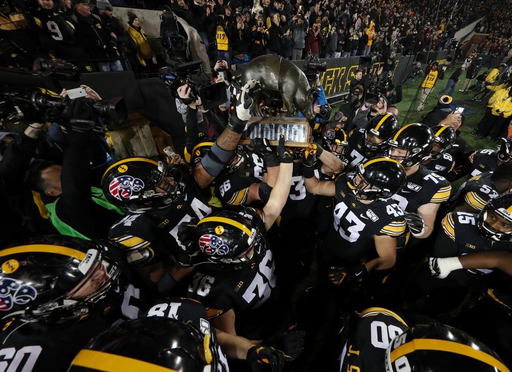 The Iowa Hawkeyes celebrate with the Floyd of Rosedale Trophy following their 23-19 victory over the Minnesota Golden Gophers Saturday, November 16, 2019 at Kinnick Stadium. (Brian Ray/hawkeyesports.com)