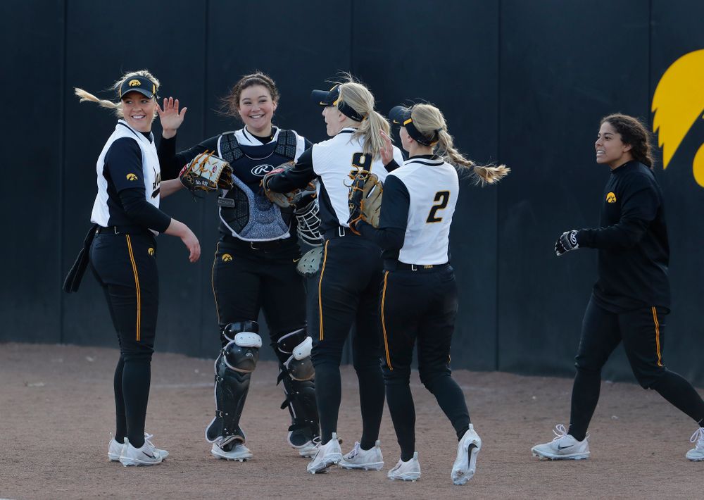 Iowa Hawkeyes starting pitcher/relief pitcher Kenzie Ihle (22) and infielder Taylor Libby (4) 