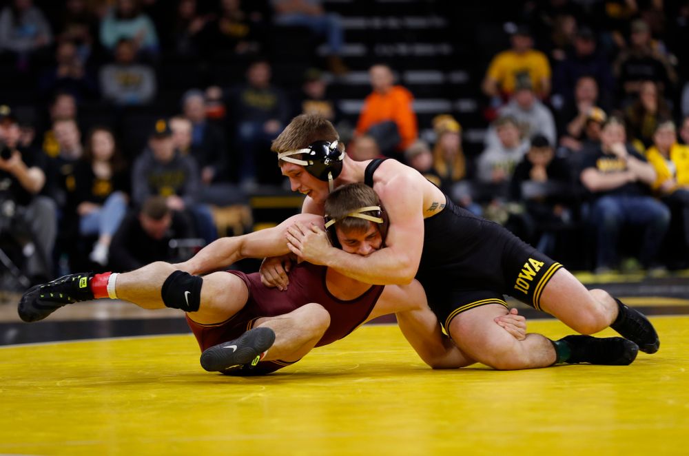 Iowa's Cash Wilcke wrestles Minnesota's Dylan Anderson at 197 pounds 