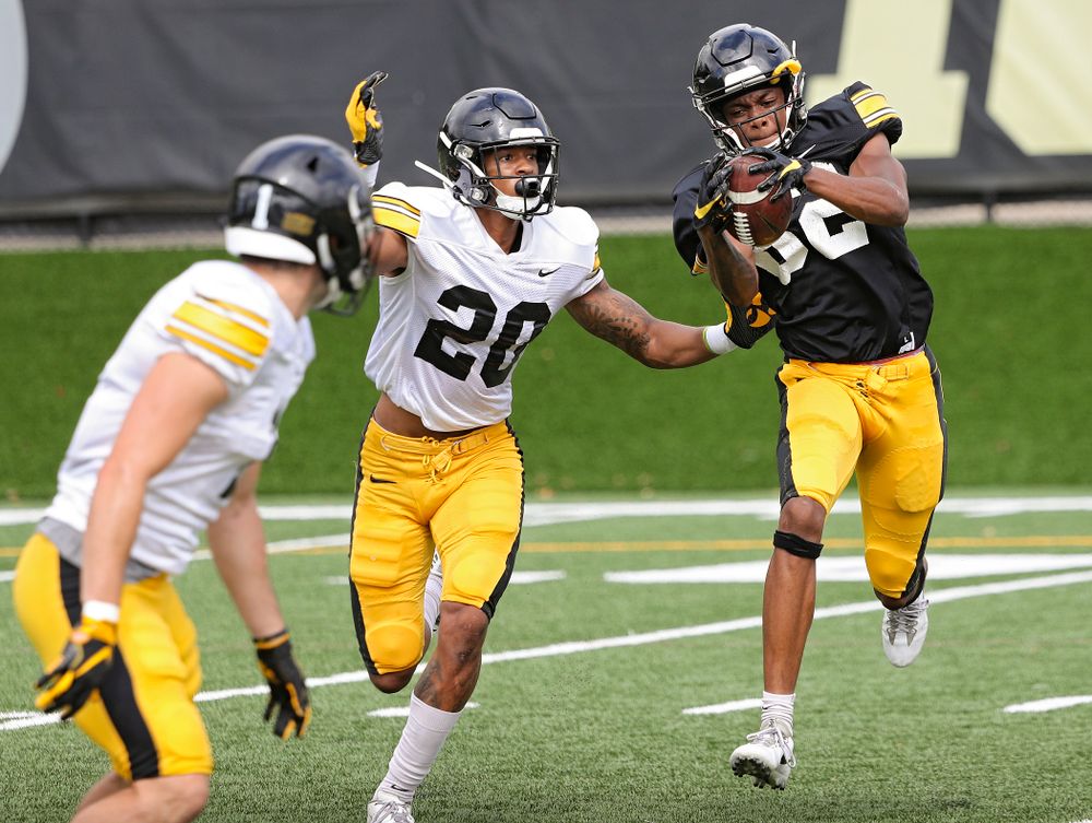 Iowa Hawkeyes wide receiver Calvin Lockett (82) pulls in a pass as defensive back Julius Brents (20) defends during Fall Camp Practice No. 10 at the Hansen Football Performance Center in Iowa City on Tuesday, Aug 13, 2019. (Stephen Mally/hawkeyesports.com)