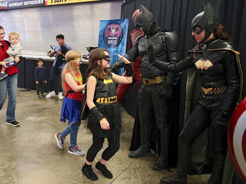 Two young fans greet superheroes on Superhero and Princess Day before the meet at Carver-Hawkeye Arena in Iowa City on Sunday, March 8, 2020. (Stephen Mally/hawkeyesports.com)