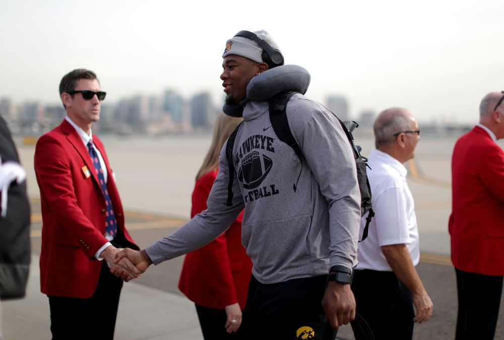 Iowa Hawkeyes defensive end Chauncey Golston (57) shakes hands with the ÒRed CoatsÓ after arriving in San Diego, CA Saturday, December 21, 2019 for the Holiday Bowl. (Brian Ray/hawkeyesports.com)
