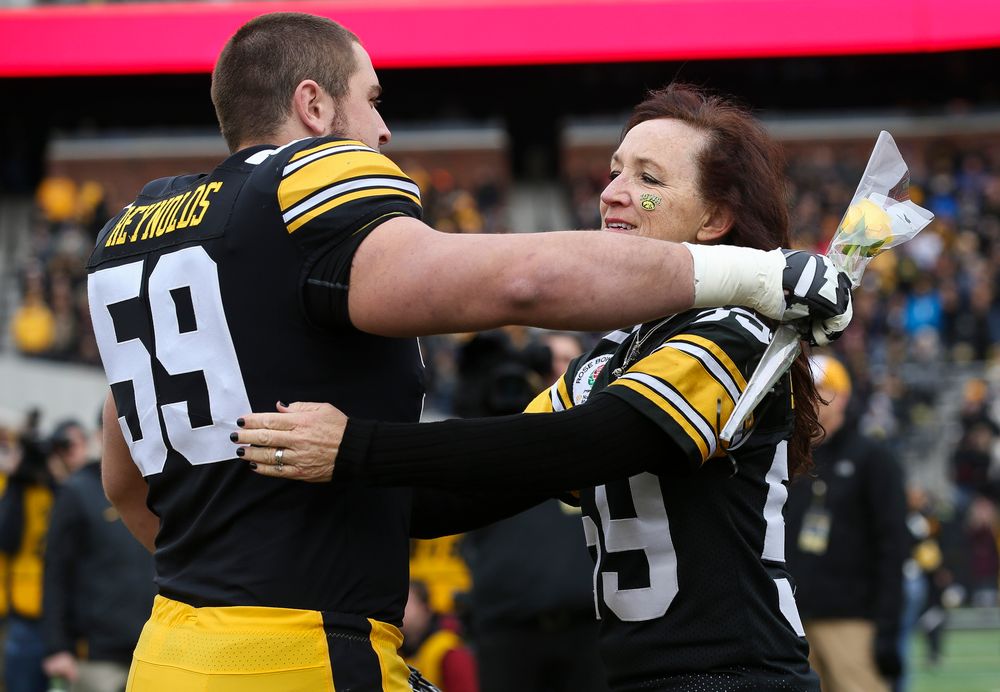 Iowa Hawkeyes offensive lineman Ross Reynolds (59) gets a hug from his mother during Senior Day ceremonies before a game against Nebraska at Kinnick Stadium on November 23, 2018. (Tork Mason/hawkeyesports.com)