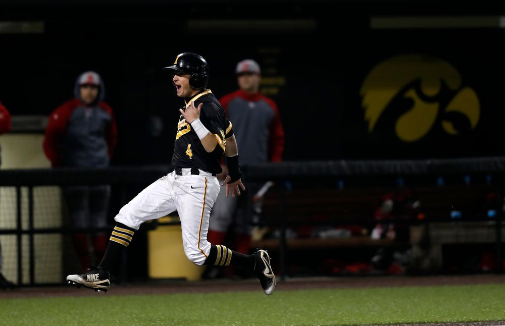 Iowa Hawkeyes infielder Mitchell Boe (4) celebrates as he scores on a walk off grand slam by catcher Tyler Cropley (5) against the Bradley Braves Wednesday, March 28, 2018 at Duane Banks Field. (Brian Ray/hawkeyesports.com)