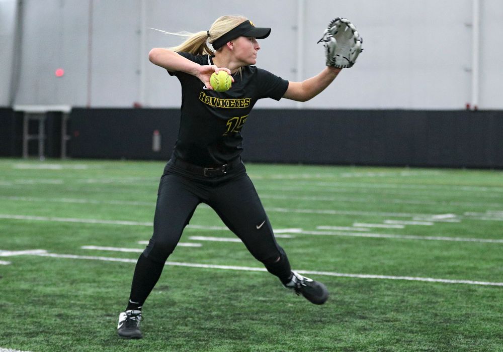 Iowa infielder Erin Carter (15) throws to first base as they run a drill during Iowa Softball Media Day at the Hawkeye Tennis and Recreation Complex in Iowa City on Thursday, January 30, 2020. (Stephen Mally/hawkeyesports.com)