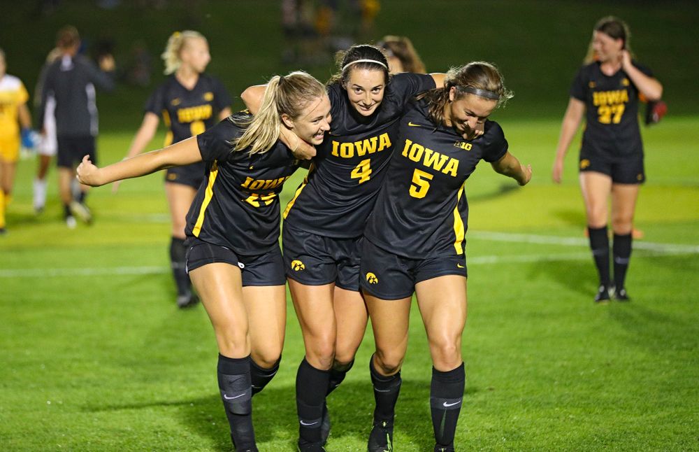 Iowa defender Sara Wheaton (24), forward Kaleigh Haus (4), and defender Riley Whitaker (5) celebrate together after their match against Western Michigan at the Iowa Soccer Complex in Iowa City on Thursday, Aug 22, 2019. (Stephen Mally/hawkeyesports.com)