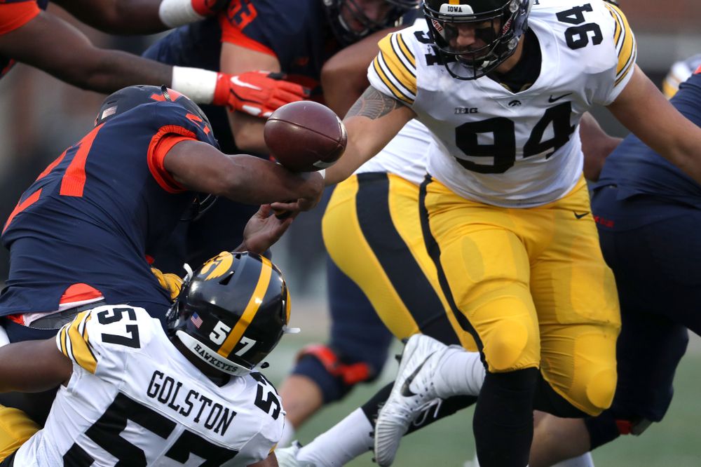 Iowa Hawkeyes defensive end A.J. Epenesa (94) and defensive end Chauncey Golston (57) cause a fumble against the Illinois Fighting Illini Saturday, November 17, 2018 at Memorial Stadium in Champaign, Ill. (Brian Ray/hawkeyesports.com)