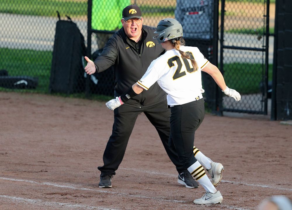 Iowa designated player Miranda Schulte (20) gets a high-five from assistant coach Rick Dillinger after hitting a home run during the sixth inning of their game against Ohio State at Pearl Field in Iowa City on Friday, May. 3, 2019. (Stephen Mally/hawkeyesports.com)
