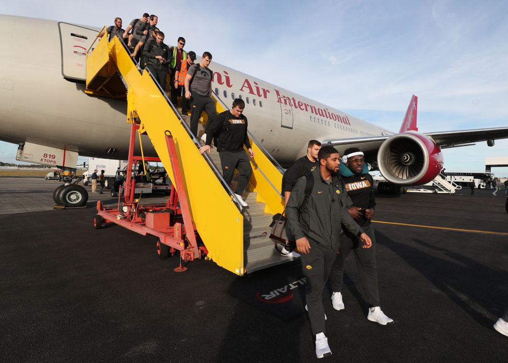 The Iowa Hawkeyes disembark the team plane Wednesday, December 26, 2018 as they arrive in Tampa, Florida for the Outback Bowl. (Brian Ray/hawkeyesports.com)