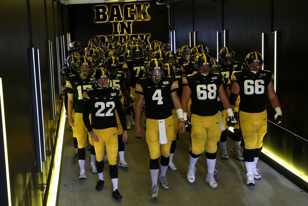The Iowa Hawkeyes swarm to the field for their game against the Purdue Boilermakers Saturday, October 19, 2019 at Kinnick Stadium. (Brian Ray/hawkeyesports.com)