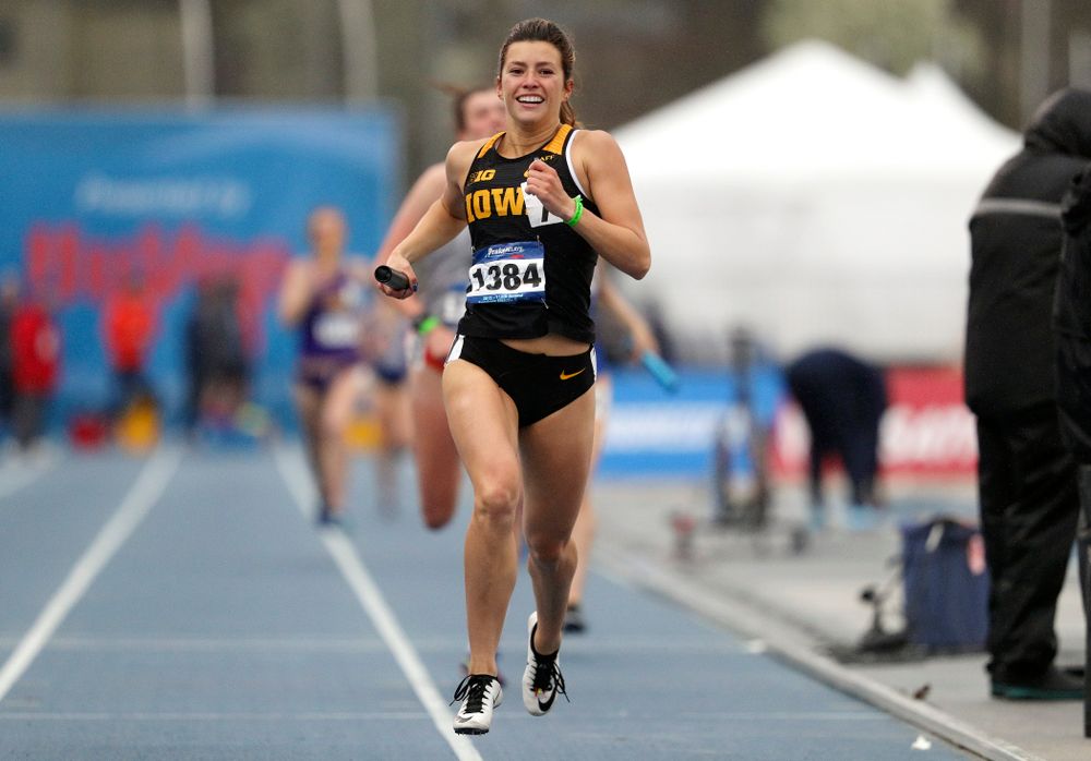 Iowa's Taylor Arco smiles as she nears the finish line while running the women's sprint medley relay event during the third day of the Drake Relays at Drake Stadium in Des Moines on Saturday, Apr. 27, 2019. (Stephen Mally/hawkeyesports.com)